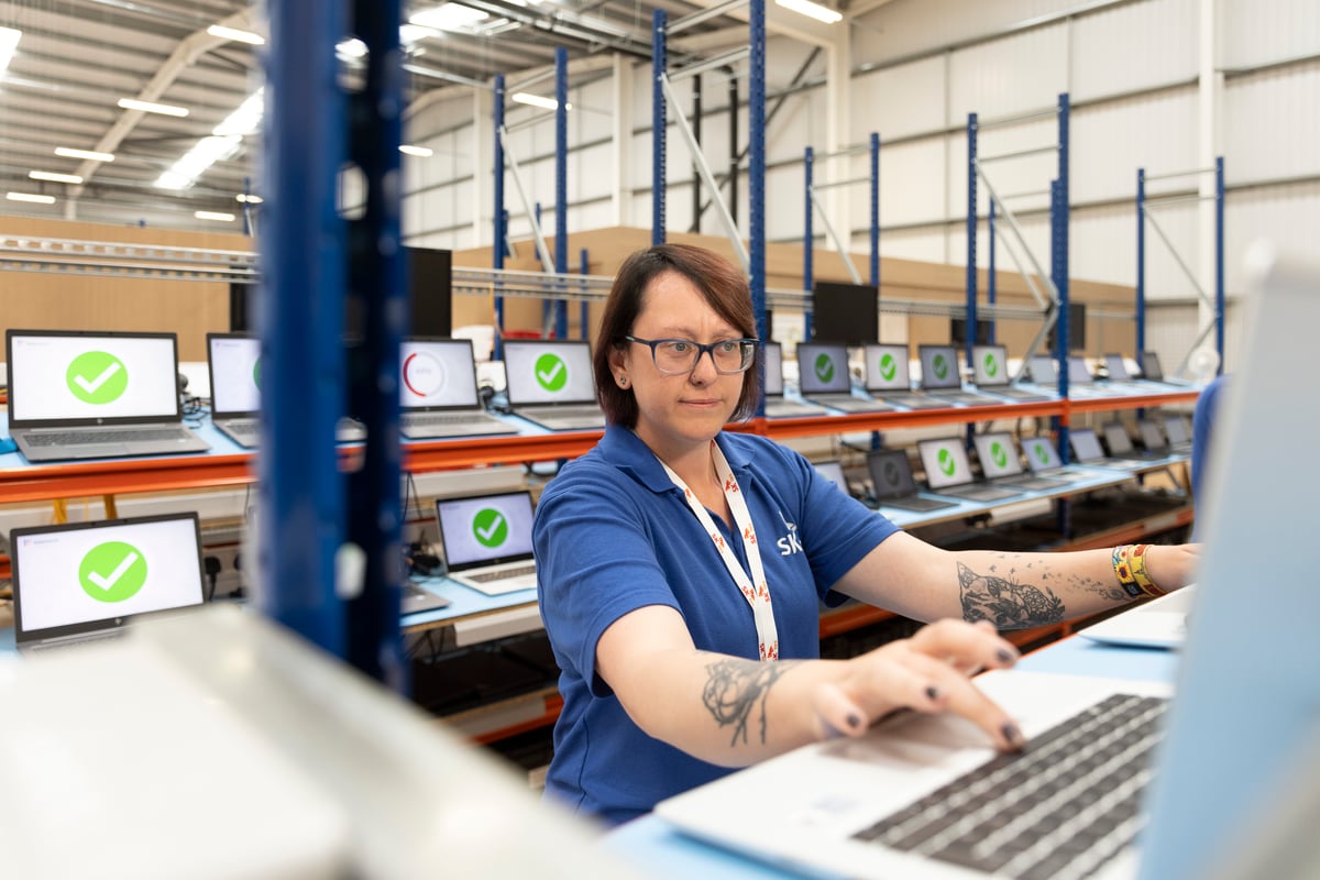 Team member works on laptop